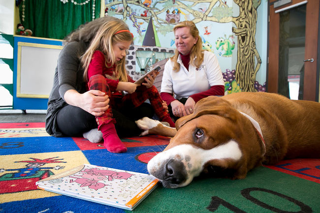 Child reading to Paws for Reading Dog 'Charlie'